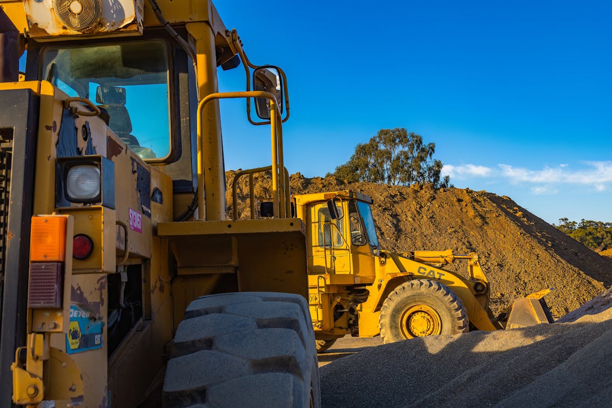 Cat wheel loaders working a gravel pit — heavy equipment JSD repairs on-site.