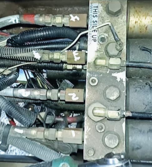 Hydraulic control valve with hoses and fittings, showcasing JSD Equipment's hydraulic repair services and expertise in mobile equipment solutions.