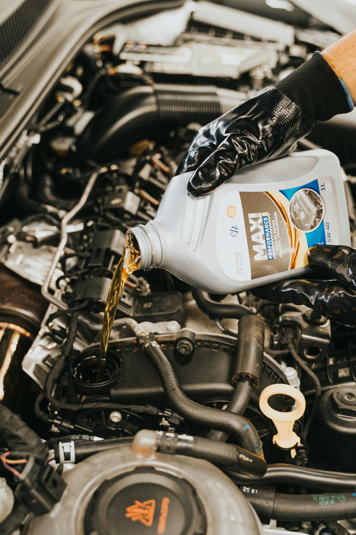 Fresh oil being poured into an engine during service.