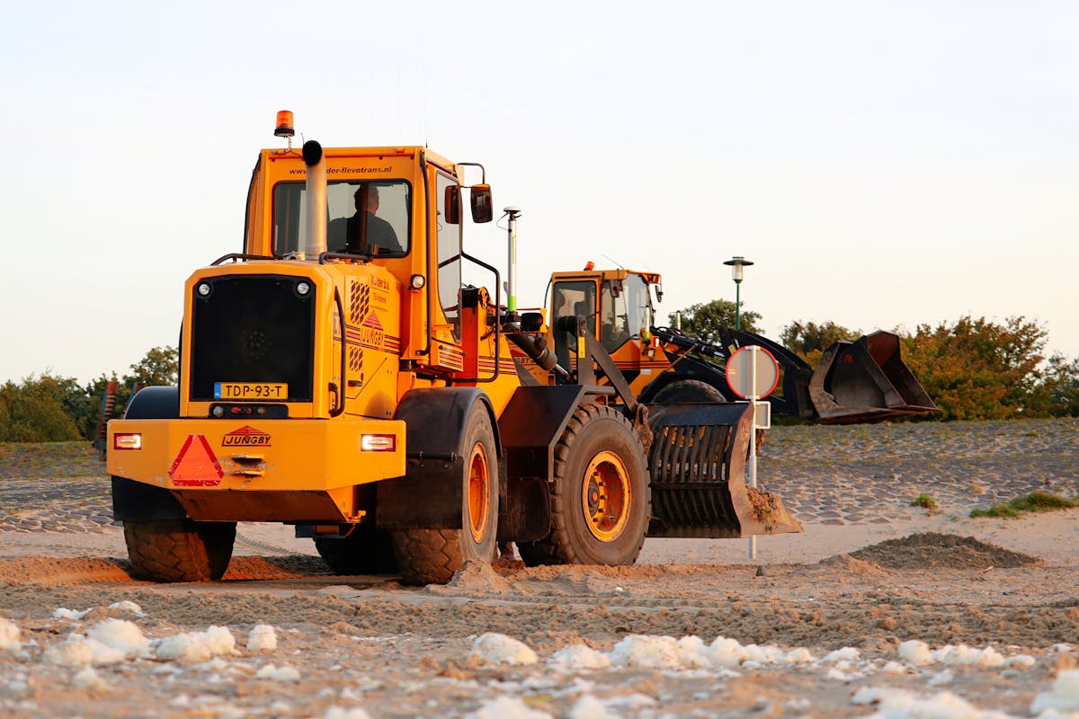 Wheel loaders on a sandy jobsite — the kind of heavy equipment JSD repairs on location across the Fraser Valley.