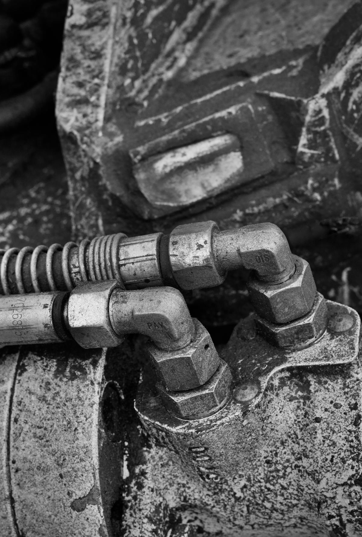 Close-up of hydraulic lines and fittings on heavy equipment.