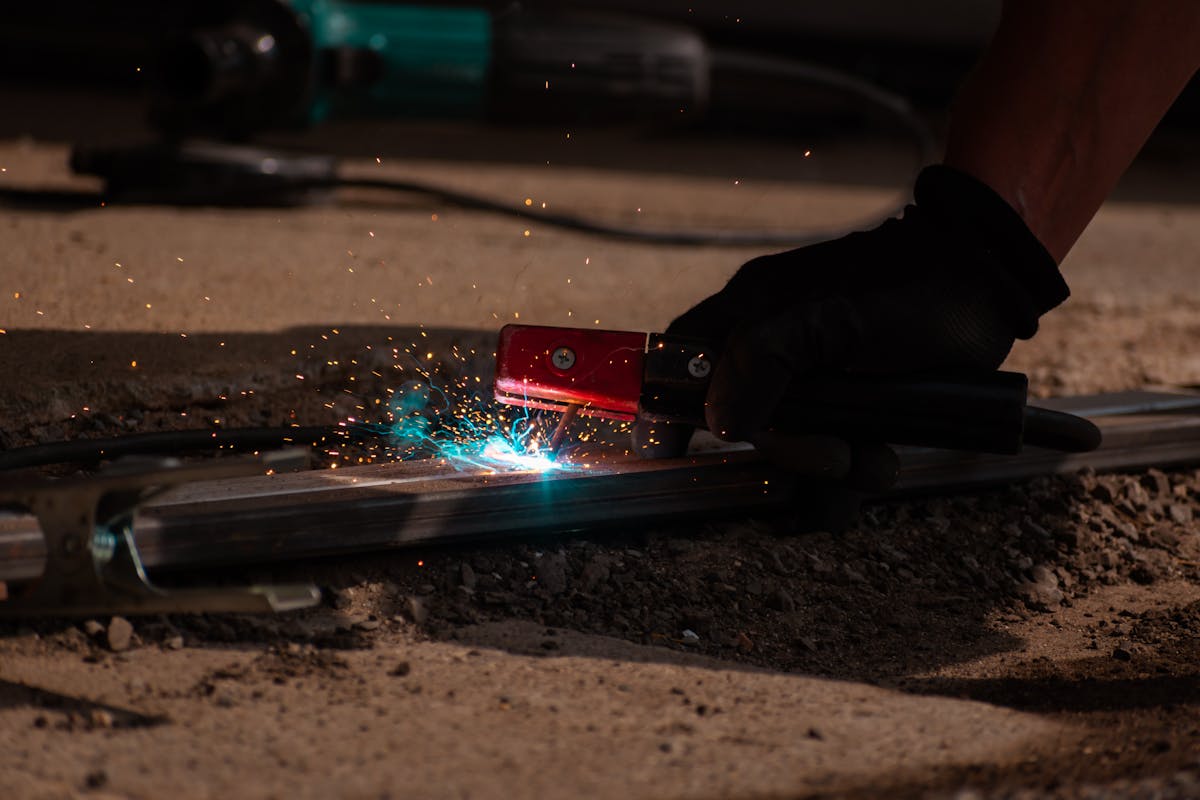 Close-up of stick welding on steel stock, building up a wear surface.