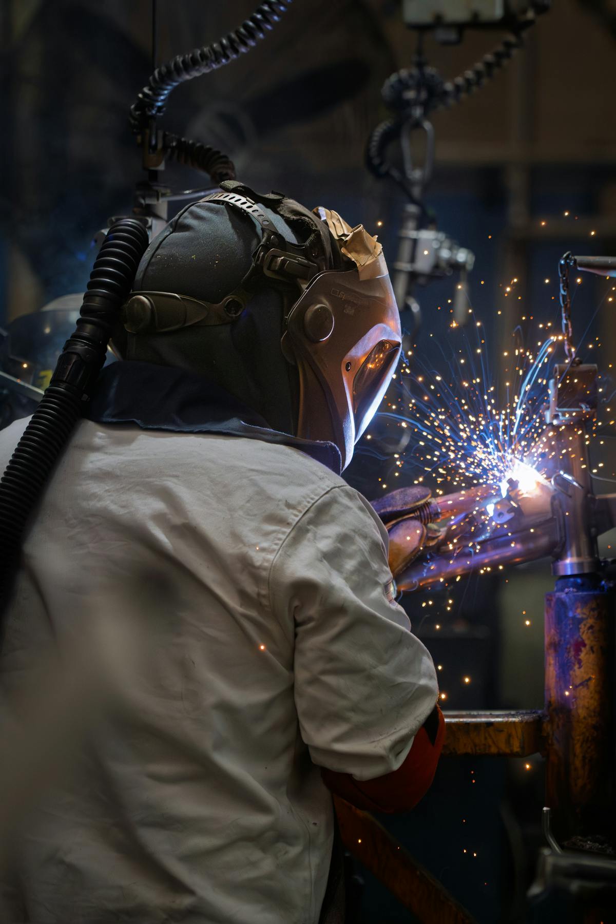 Welder running a bead in a shower of sparks.